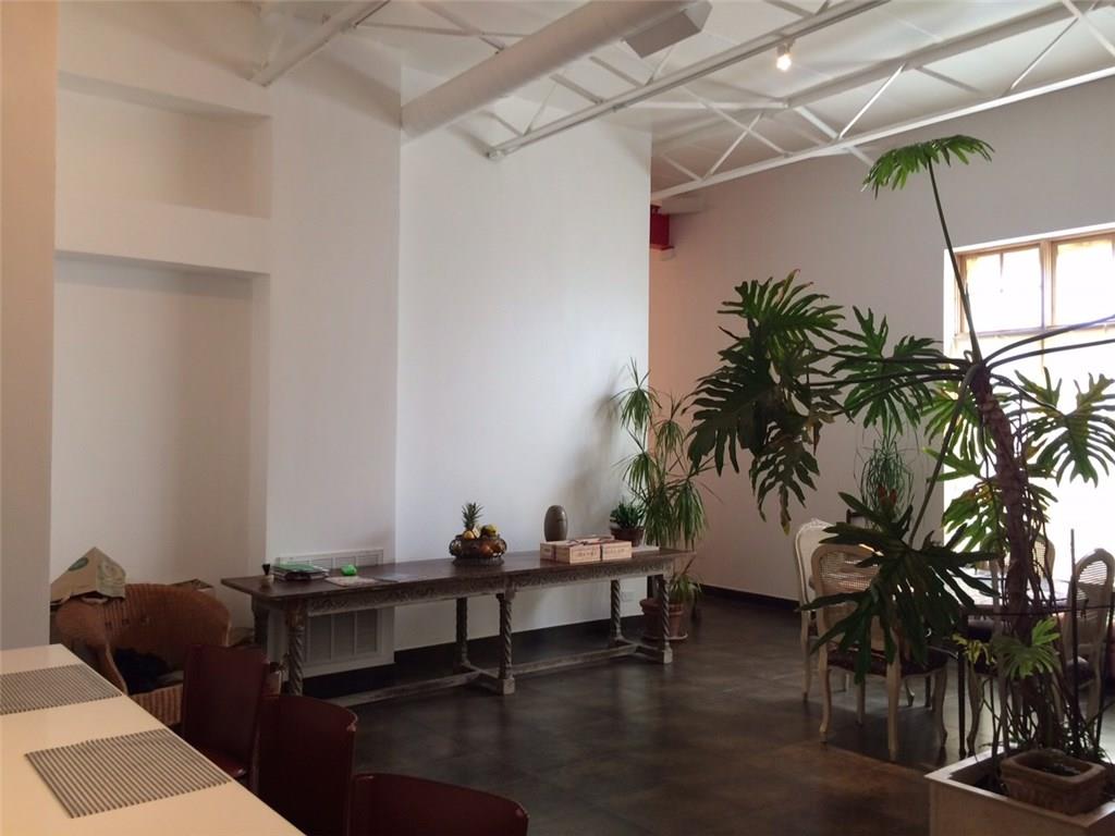 1371 Crampton Street, Unit 120 Dallas, TX 75207 - Photo 4 of 10 a living room with furniture and a potted plant