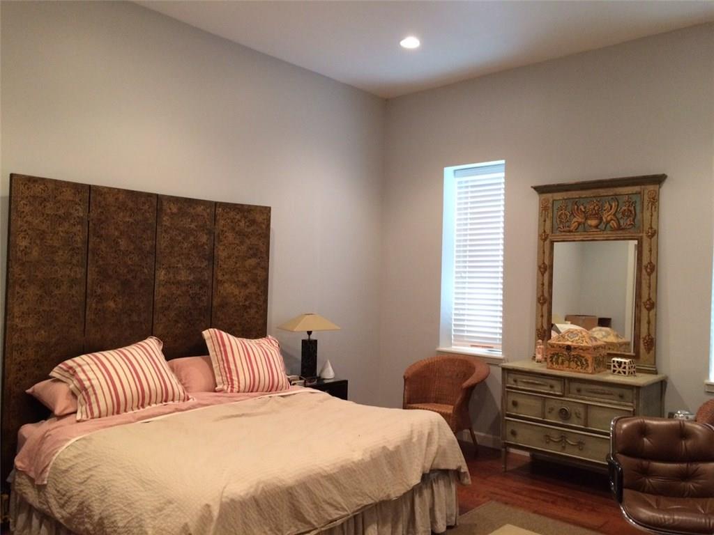 1371 Crampton Street, Unit 120 Dallas, TX 75207 - Photo 8 of 10 a bedroom with a bed and wooden floor