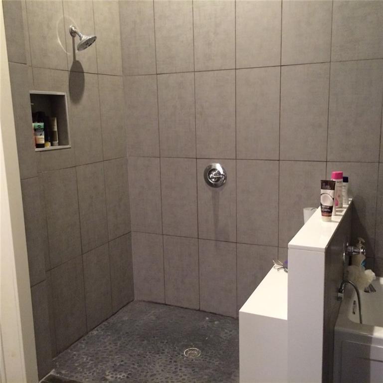 1371 Crampton Street, Unit 120 Dallas, TX 75207 - Photo 9 of 10 a bathroom with a sink and shower