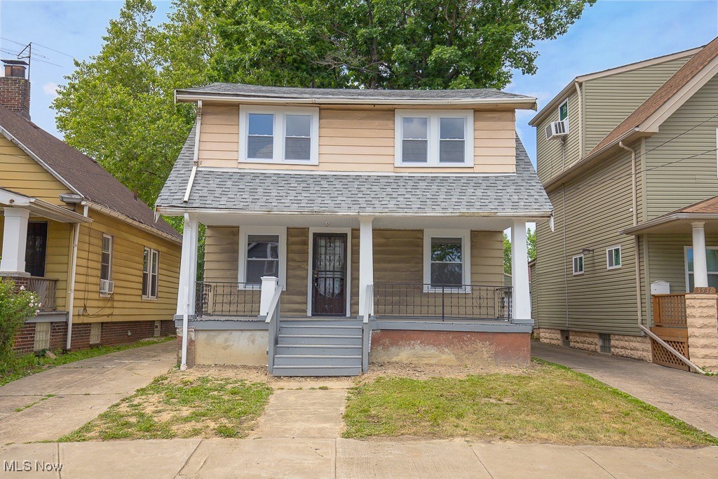 3538 Independence Road Cleveland, OH 44105 - Photo 1 of 24 View of front of house featuring a porch, a shingled roof, and cooling unit
