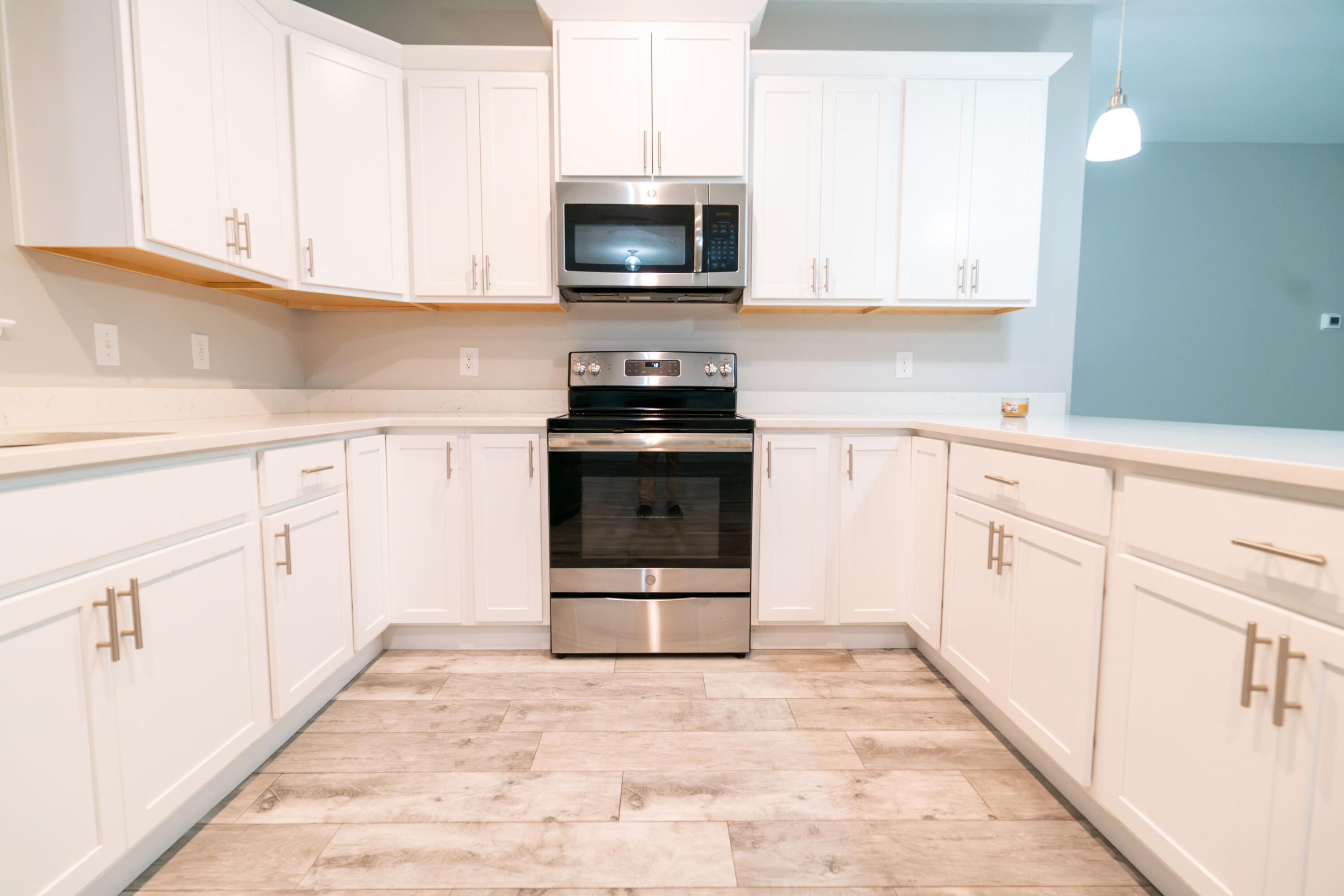 2243 Wind Trace Road North Navarre, FL 32566 - Photo 10 of 34 a kitchen with white cabinets appliances and a sink