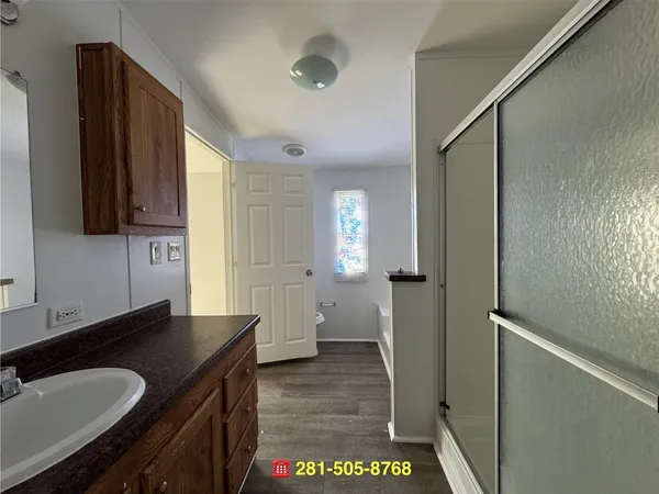a bathroom with a sink a mirror and a shower