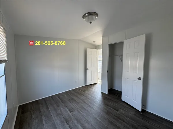 a view of hallway with wooden floor