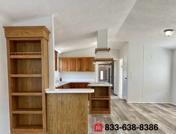 a view of kitchen with cabinets and window