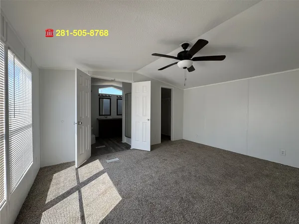 a view of a livingroom with a ceiling fan and window