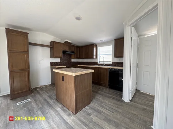 a kitchen with a sink stove and refrigerator