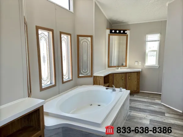 a bathroom with a bathtub a sink and a window