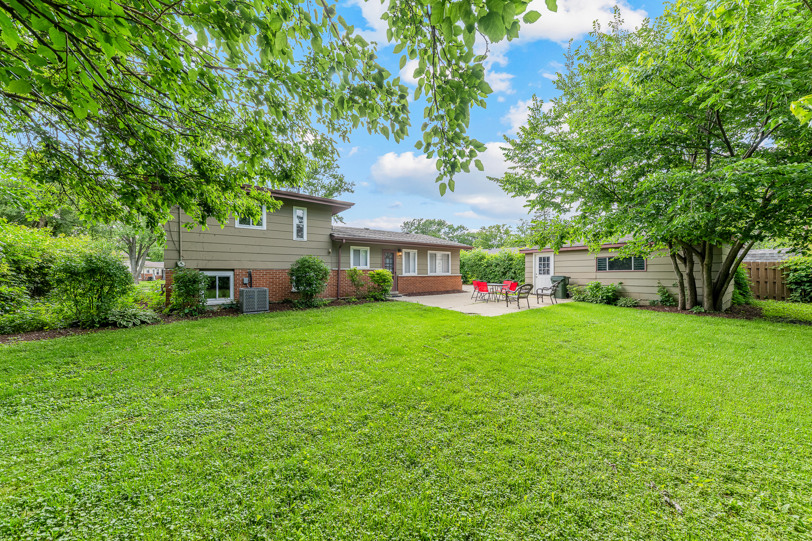 303 Springfield Street Park Forest, IL 60466 - Photo 16 of 16 a view of an house with backyard space and garden