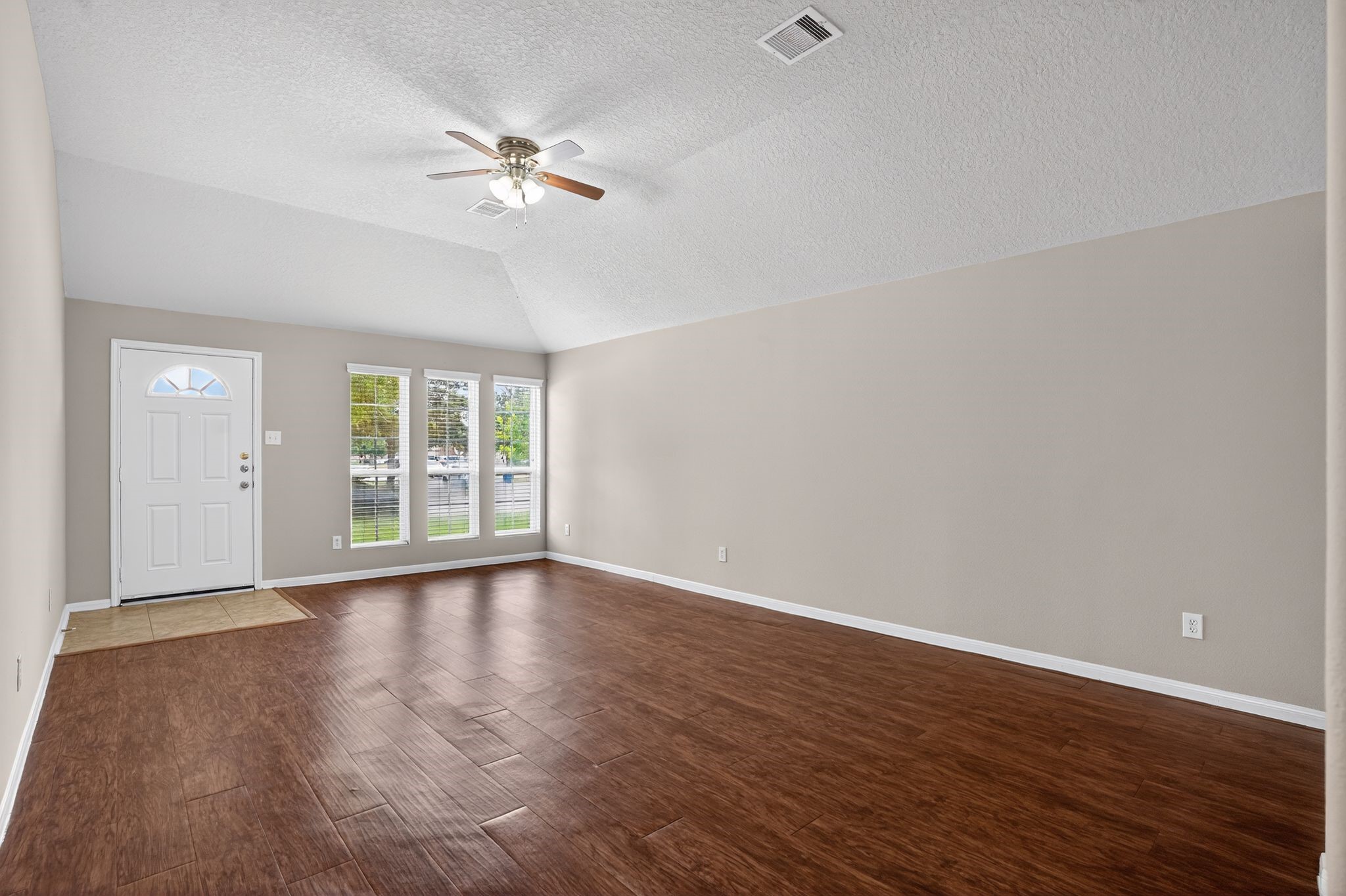 29414 Winton Wood Way Spring, TX 77386 - Photo 29 of 35 a view of an empty room with wooden floor and a window