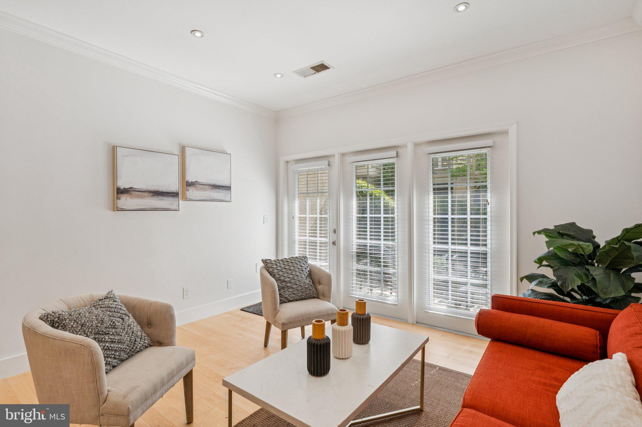 11800 Old Georgetown Road, Unit 1120 North Bethesda, MD 20852 - Photo 1 of 36 a living room with furniture and a large window