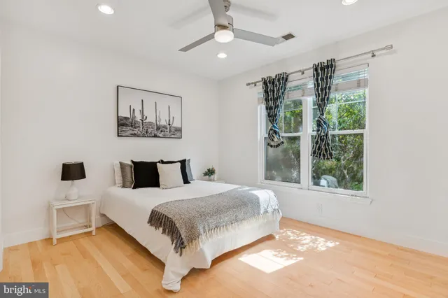 a bedroom with a large bed and a window
