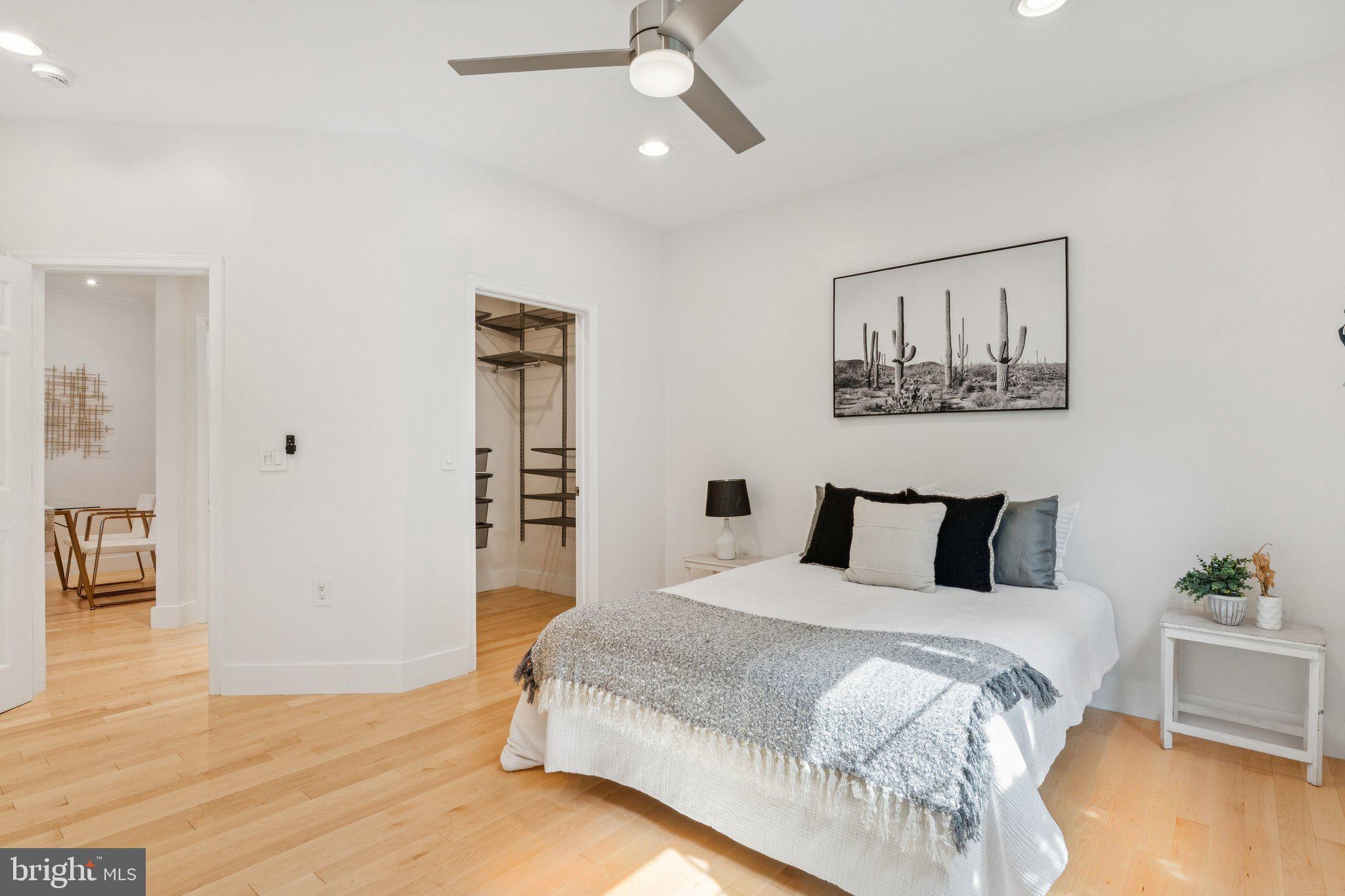 11800 Old Georgetown Road, Unit 1120 North Bethesda, MD 20852 - Photo 14 of 36 a bedroom with a large bed and a chandelier