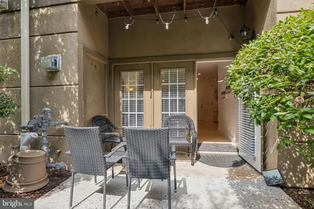 a view of a patio with table and chairs and potted plants