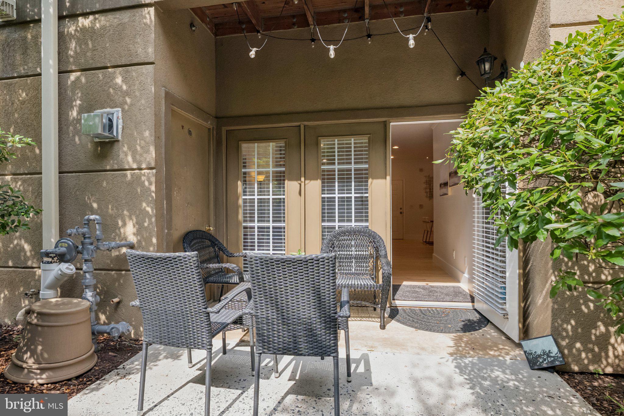 11800 Old Georgetown Road, Unit 1120 North Bethesda, MD 20852 - Photo 2 of 36 a view of a patio with table and chairs and potted plants