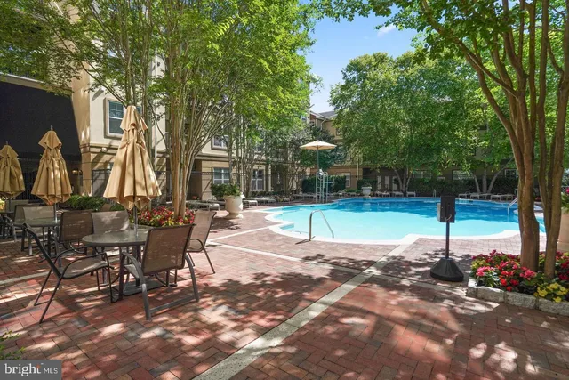 a view of a swimming pool with sitting area