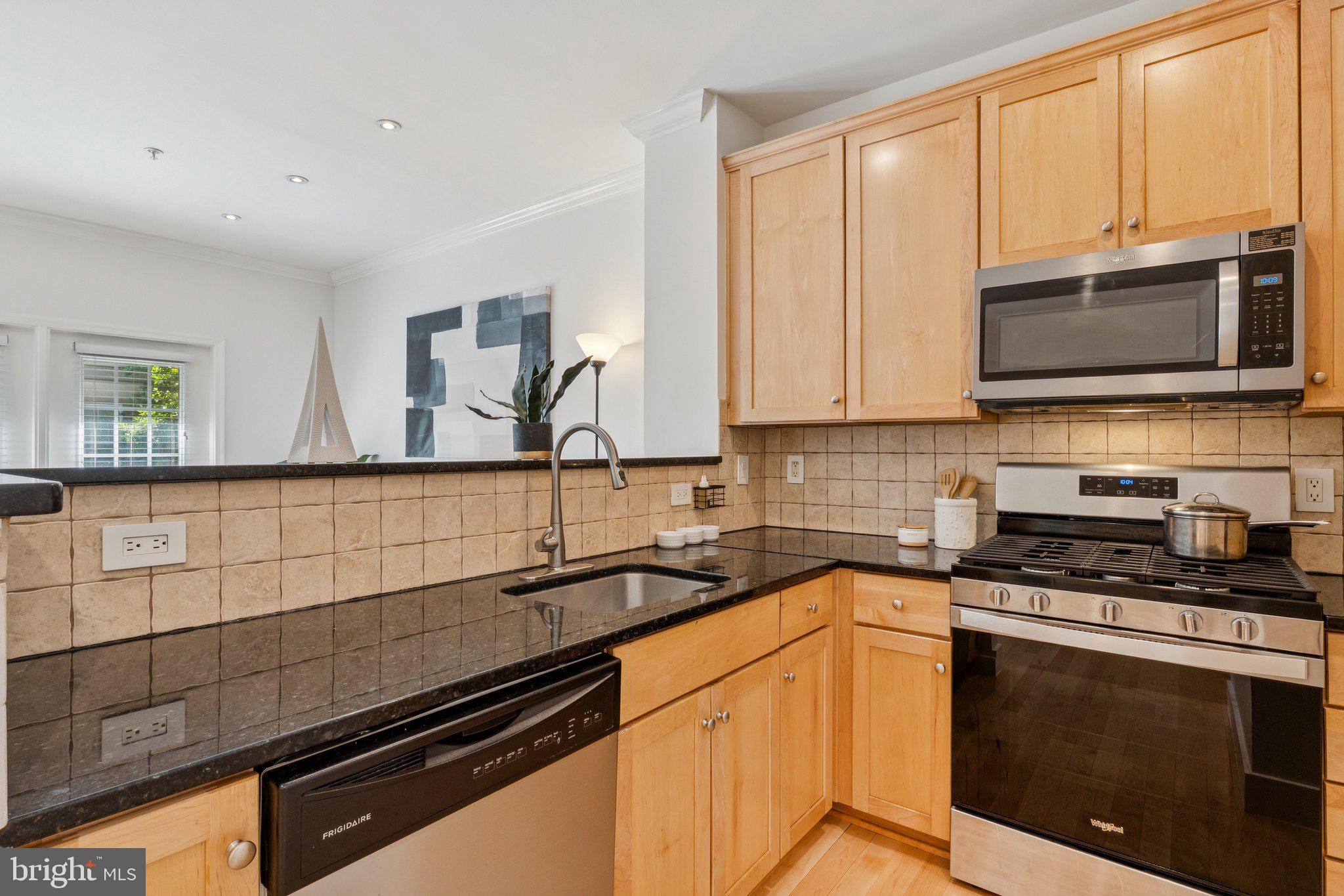 11800 Old Georgetown Road, Unit 1120 North Bethesda, MD 20852 - Photo 8 of 36 a kitchen with stainless steel appliances a sink stove and microwave