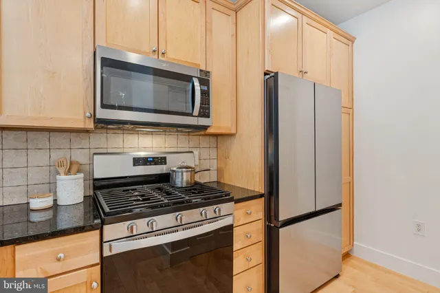 a kitchen with a refrigerator stove and microwave