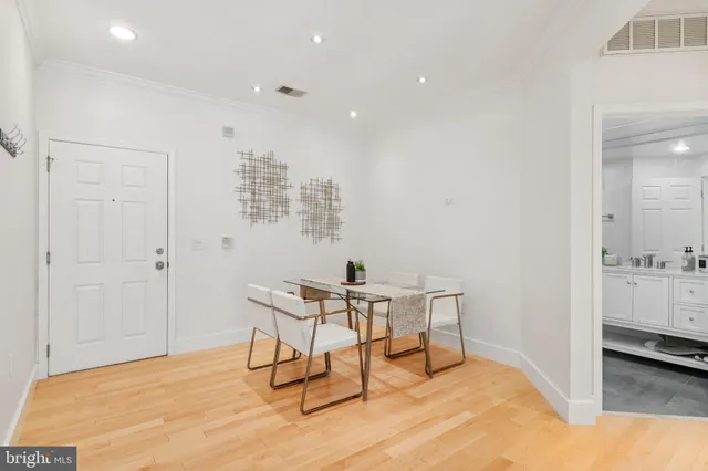 a view of a room with furniture and wooden floor