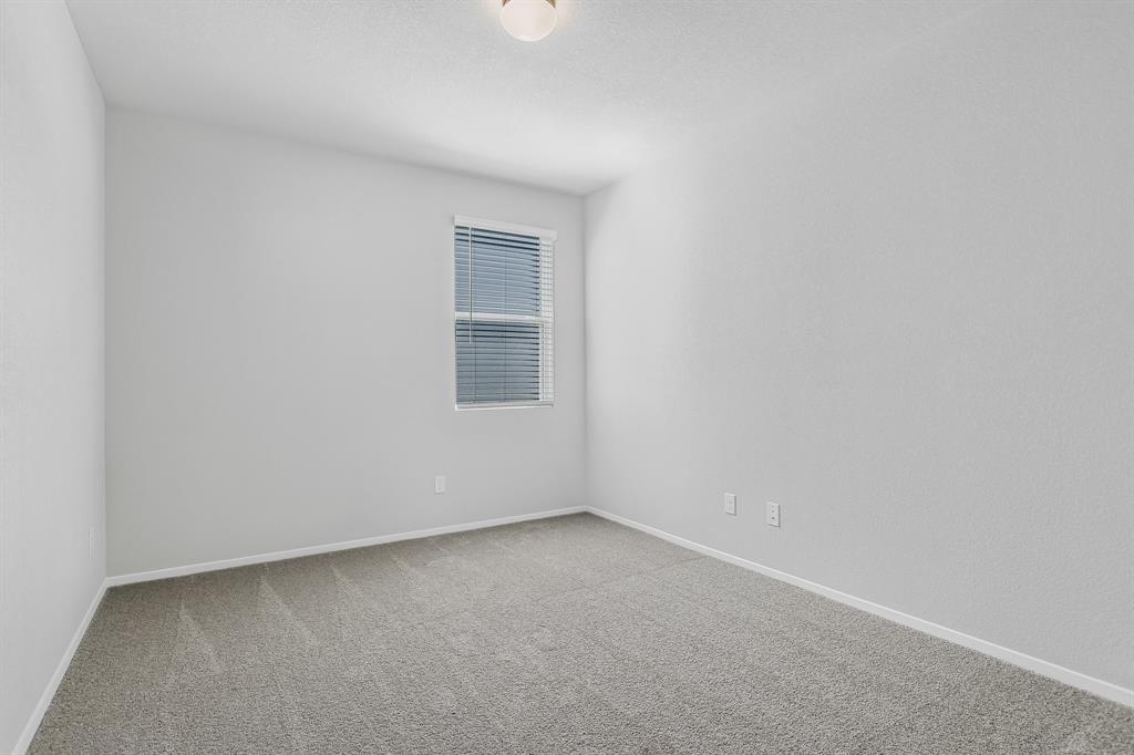 2808 Totley Road Manor, TX 78653 - Photo 17 of 21 Neutral-toned room featuring light gray walls and plush gray carpeting
