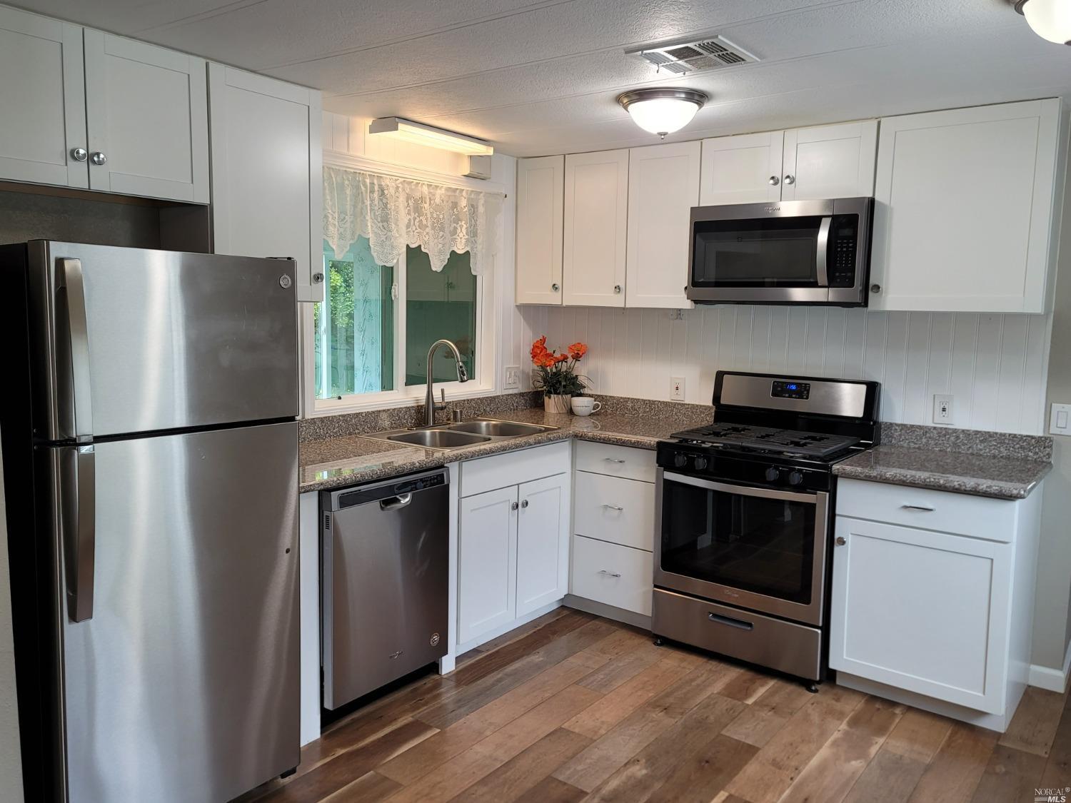 a kitchen with a refrigerator stove and microwave