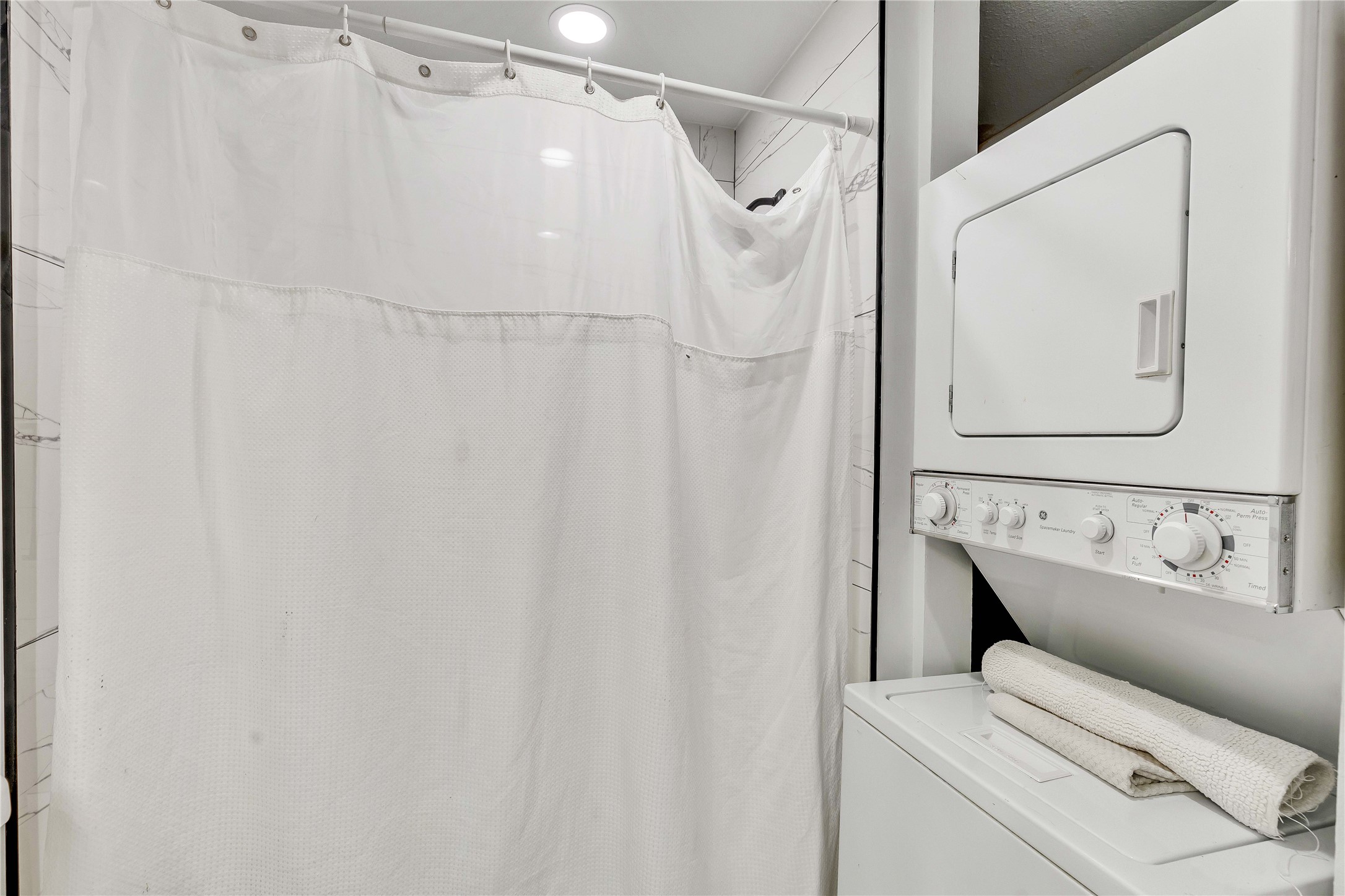 2529 Rio Grande Street, Unit 56 Austin, TX 78705 - Photo 16 of 16 Clothes washing area featuring stacked washer and dryer and laundry area
