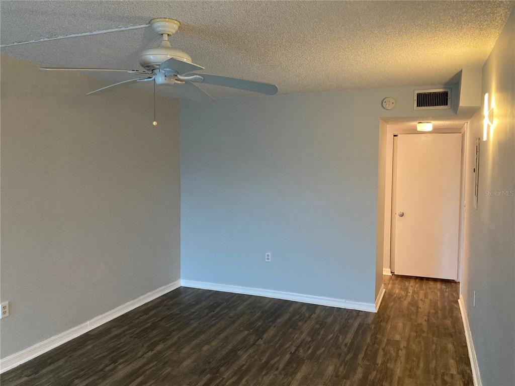 4908 38th Way South, Unit 303 St. Petersburg, FL 33711 - Photo 11 of 14 an empty room with wooden floor