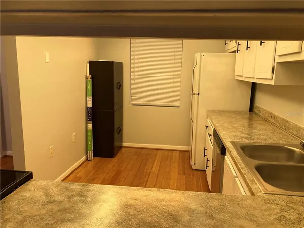 a kitchen with a sink and a refrigerator