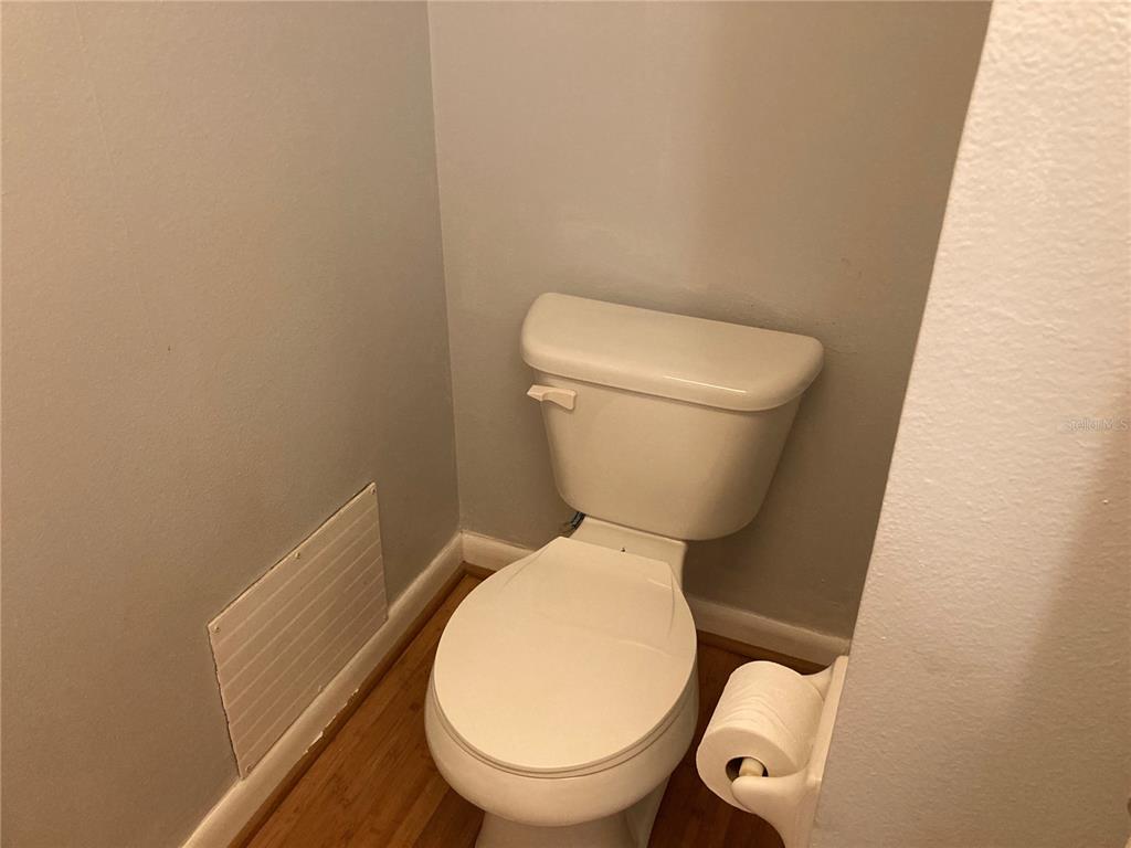 4908 38th Way South, Unit 303 St. Petersburg, FL 33711 - Photo 9 of 14 a white toilet sitting next to a white wall