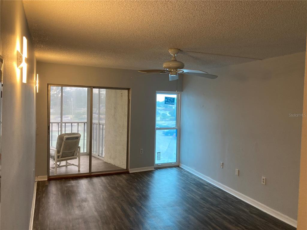 4908 38th Way South, Unit 303 St. Petersburg, FL 33711 - Photo 10 of 14 a view of an empty room with wooden floor and a window