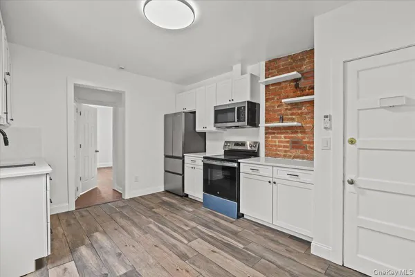 a kitchen with a refrigerator stove and sink