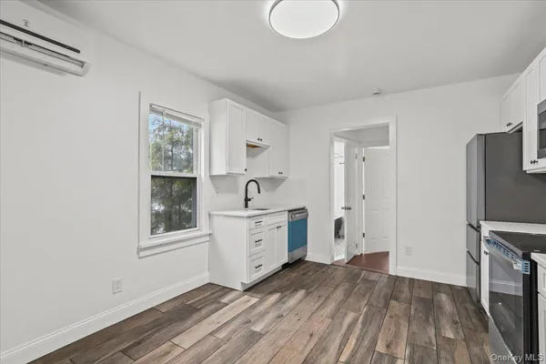 a room with a hardwood floor and a window