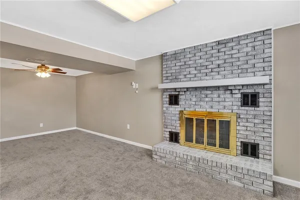 a view of an empty room with a fireplace