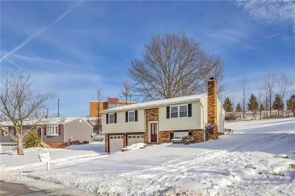 a view of a house with snow on the road