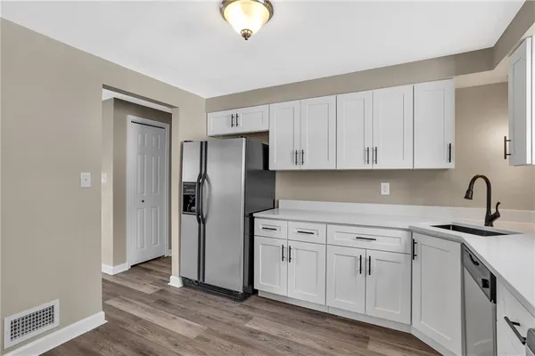 a kitchen with cabinets appliances and a sink