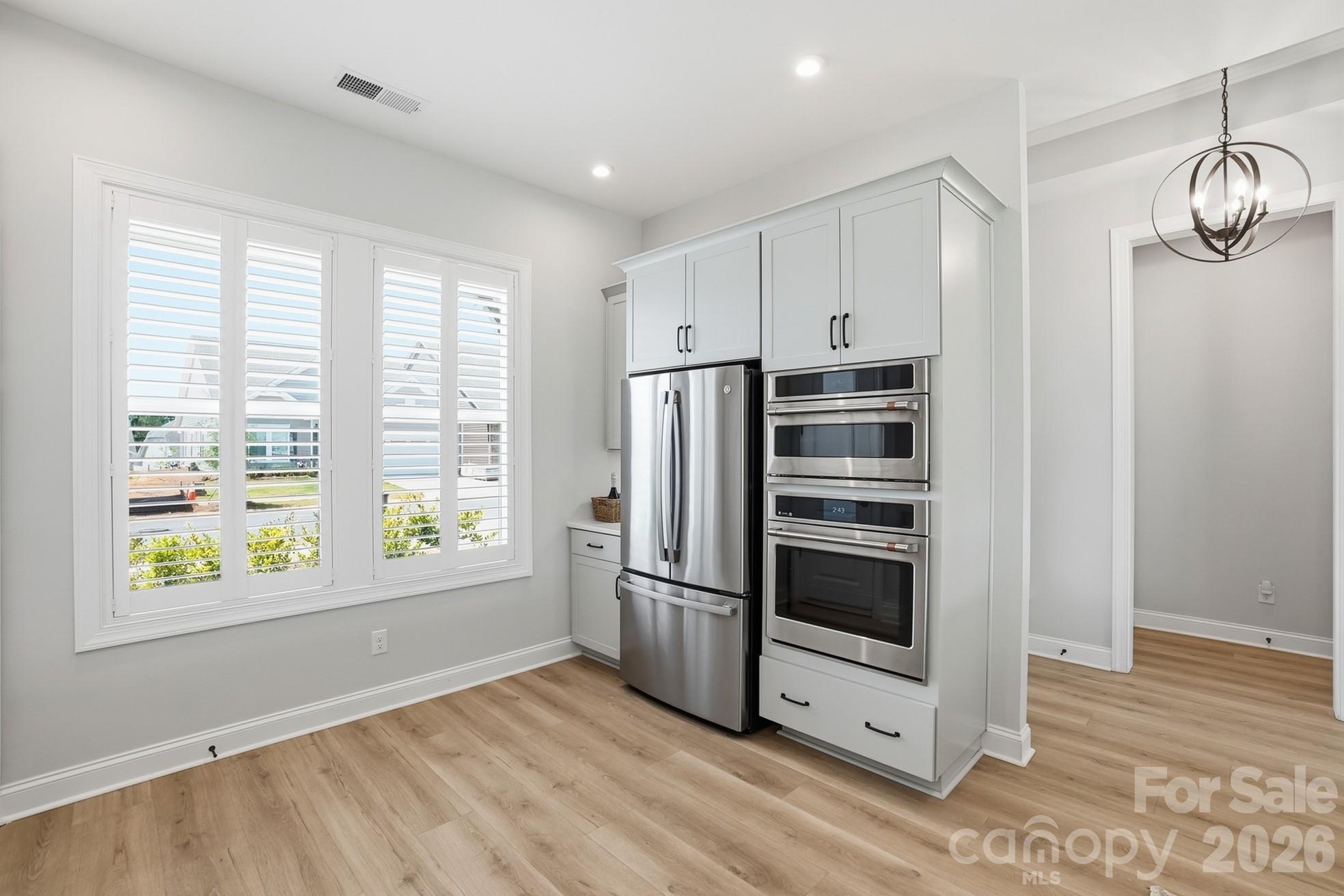 1035 Rabbit Hl Lane Monroe, NC 28110 - Photo 12 of 39 a kitchen with stainless steel appliances a refrigerator and a window