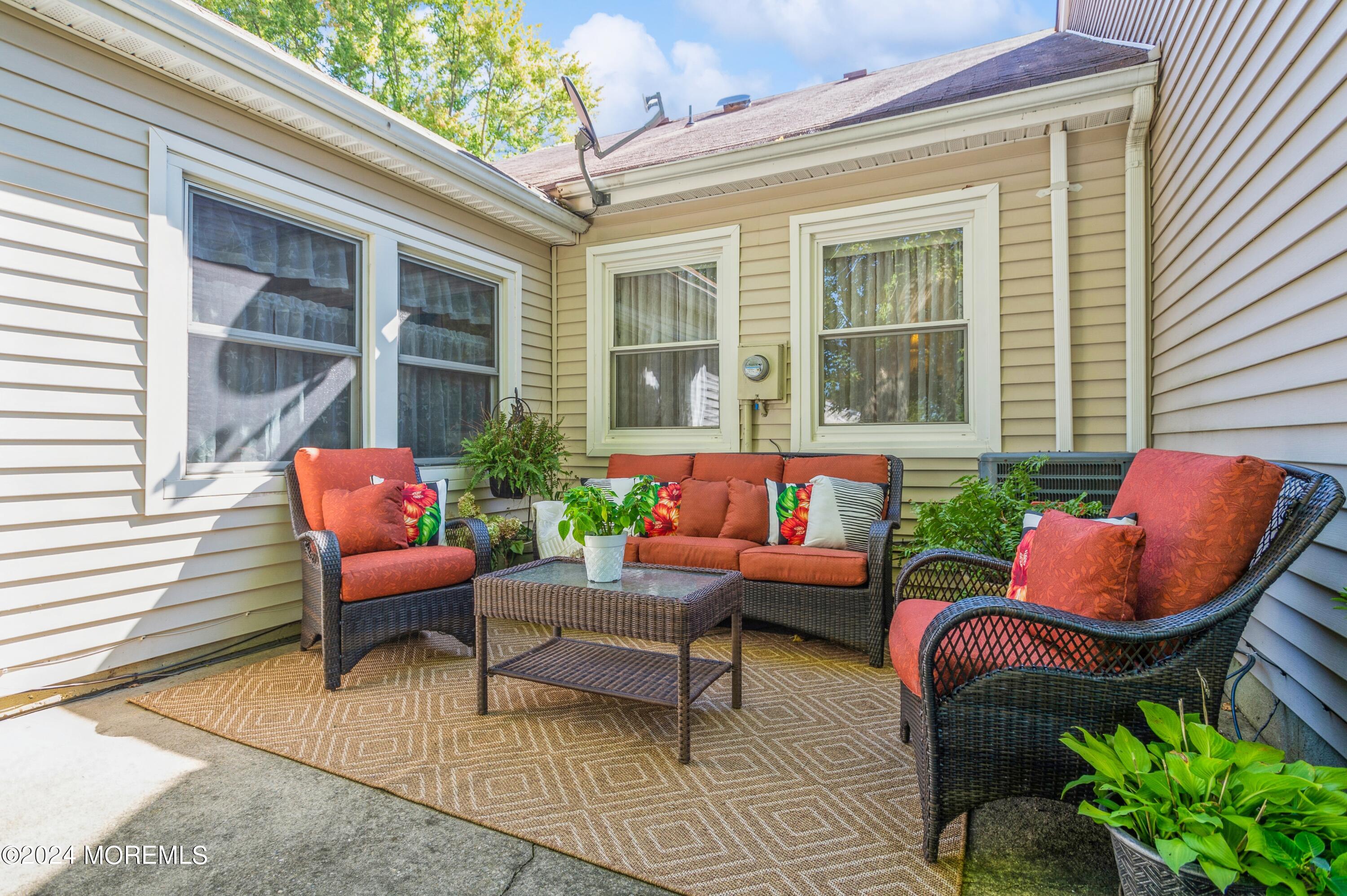 147 B Cours De Pasteur, Unit 1000 Freehold, NJ 07728 - Photo 20 of 28 a outdoor living space with furniture and a potted plant
