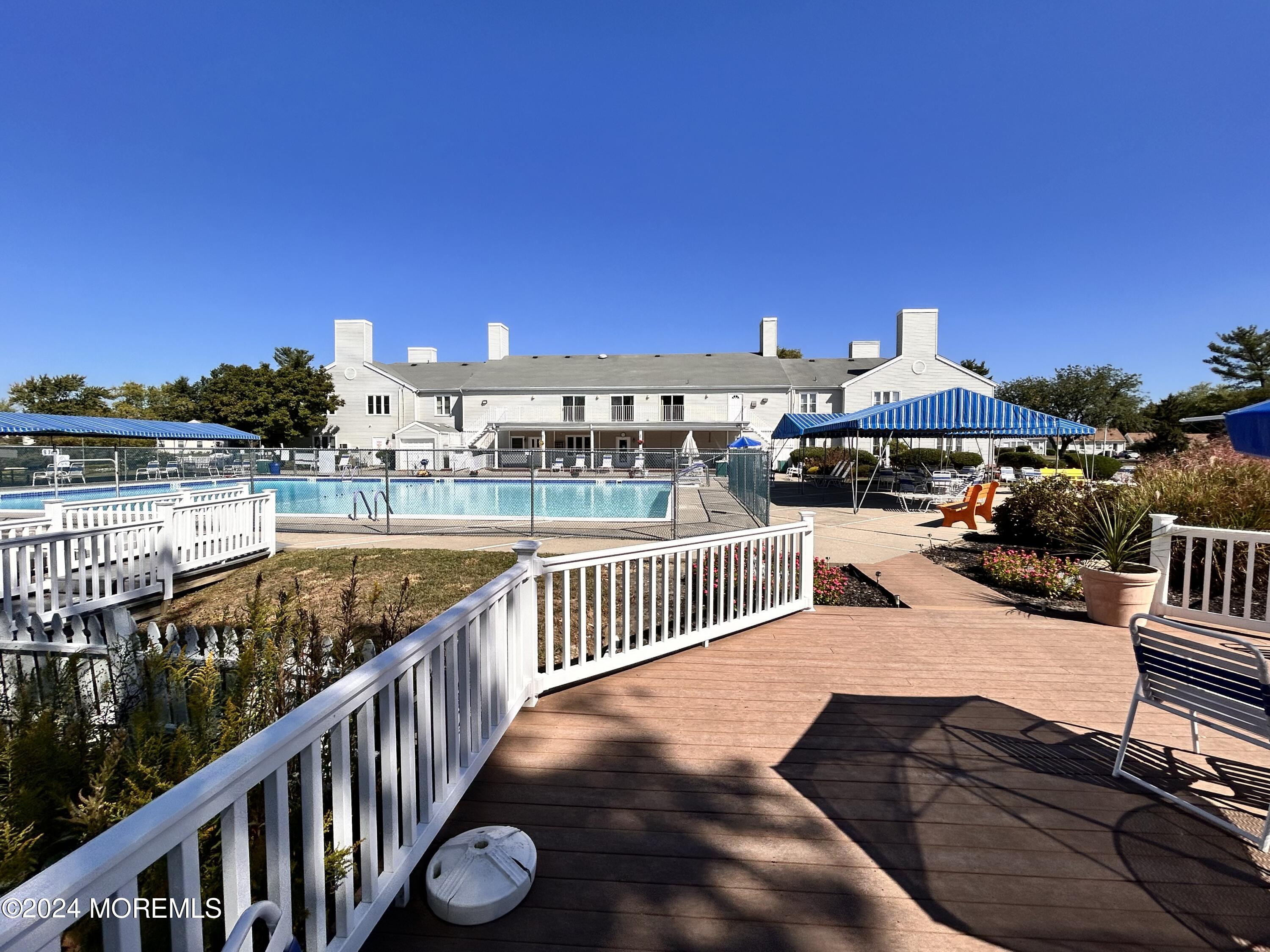 147 B Cours De Pasteur, Unit 1000 Freehold, NJ 07728 - Photo 27 of 28 a view of a swimming pool with furniture