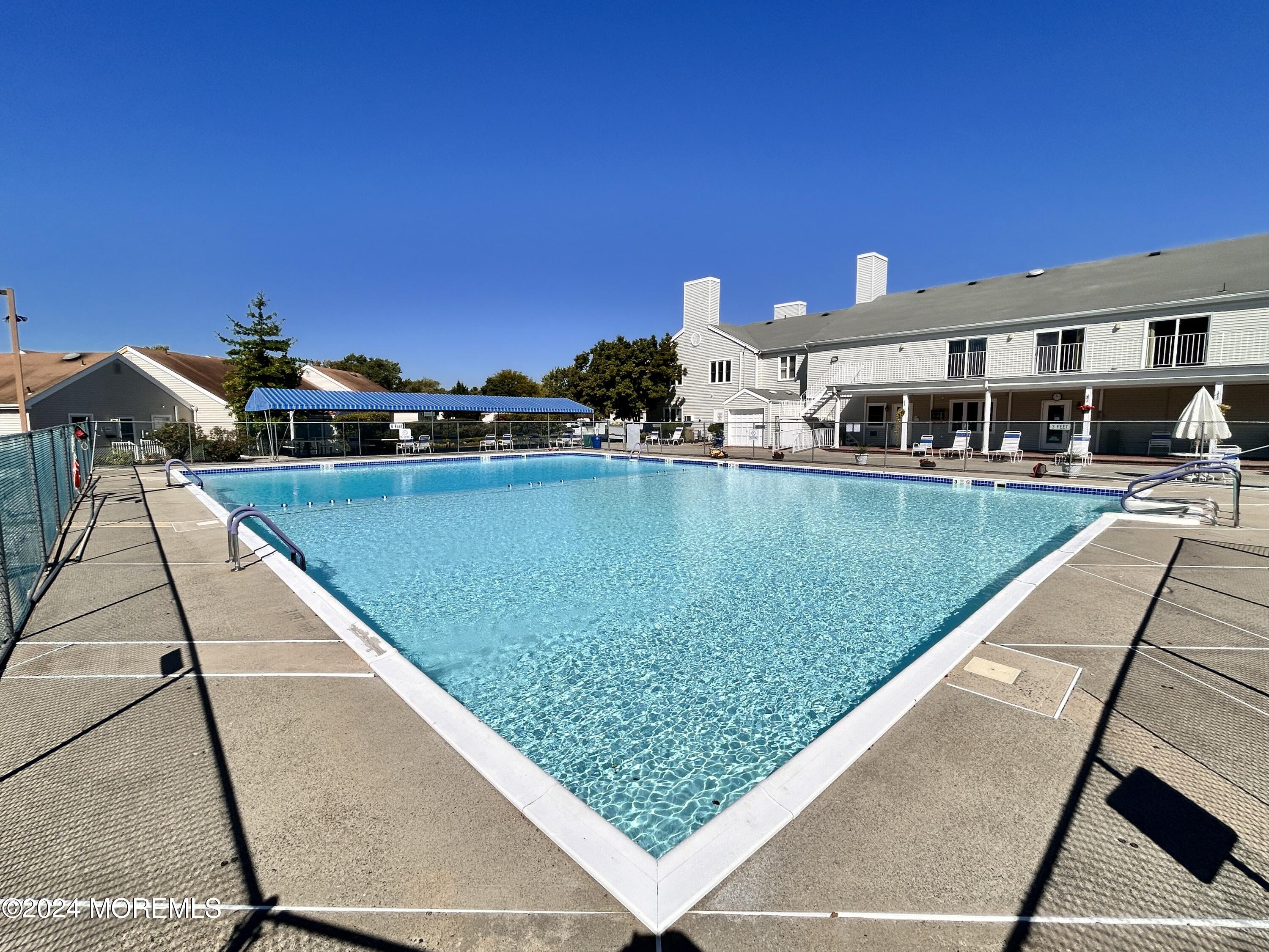 147 B Cours De Pasteur, Unit 1000 Freehold, NJ 07728 - Photo 28 of 28 a view of swimming pool with a lounge chairs