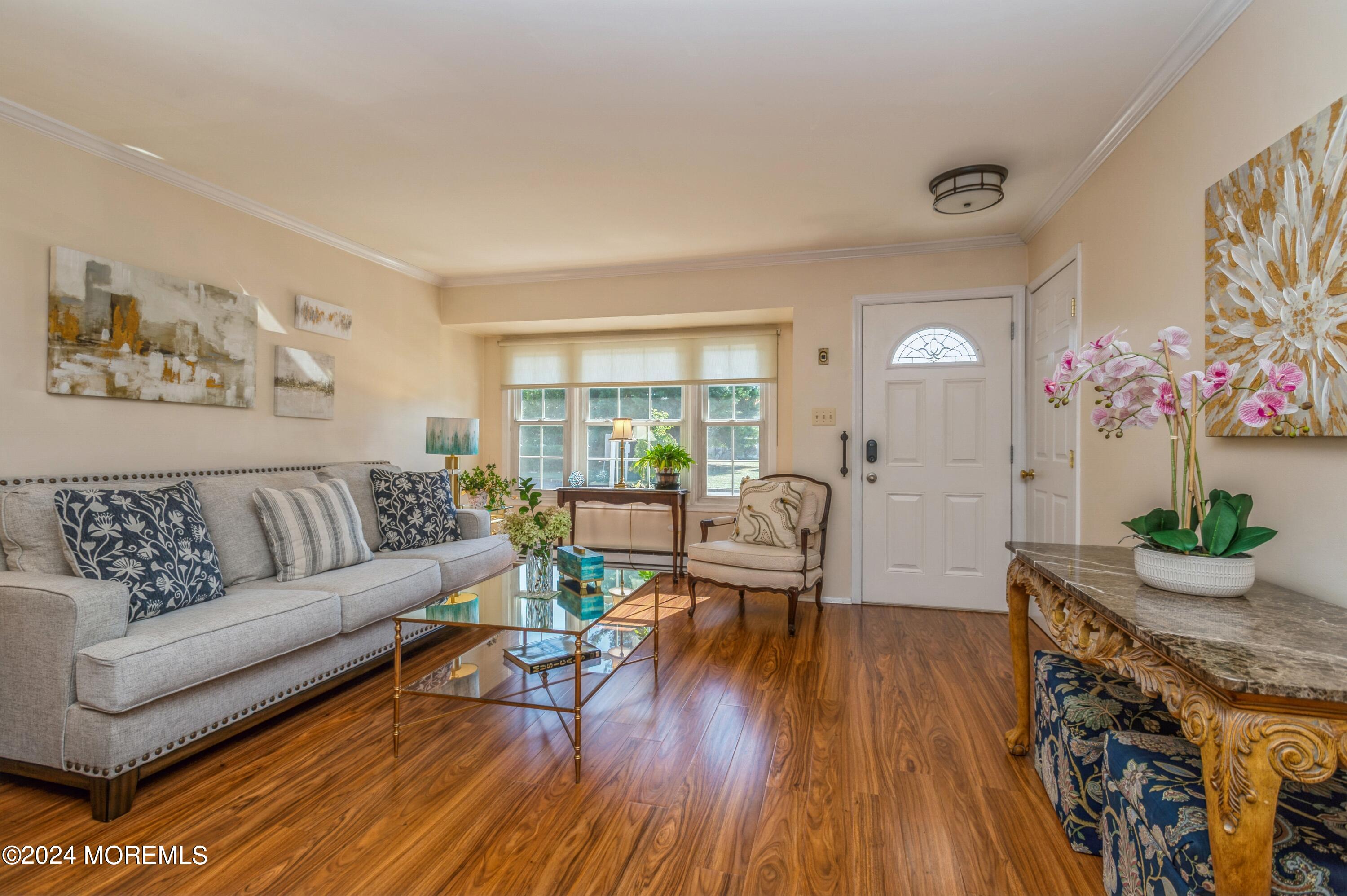 147 B Cours De Pasteur, Unit 1000 Freehold, NJ 07728 - Photo 3 of 28 a living room with furniture and wooden floor