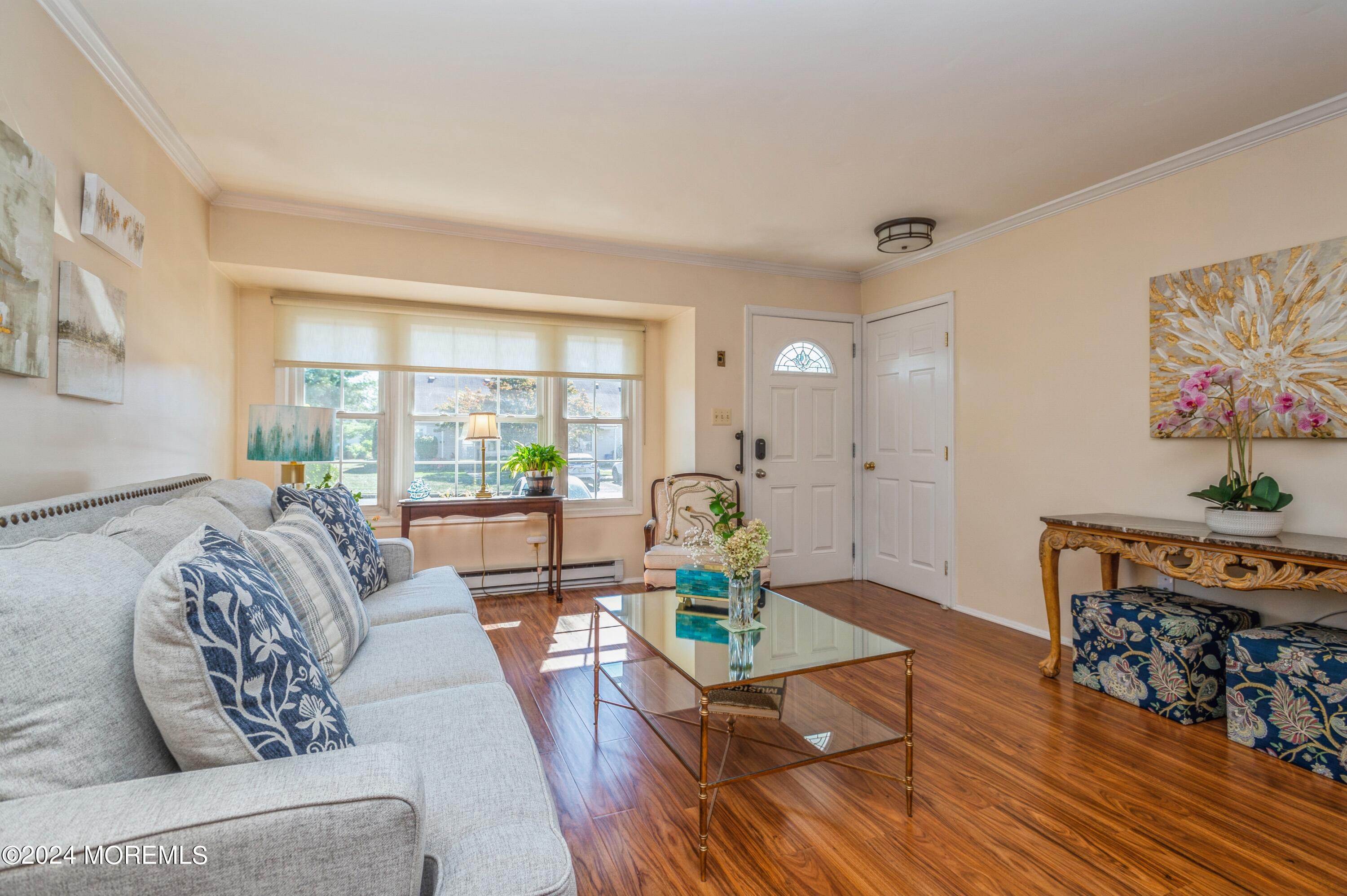 147 B Cours De Pasteur, Unit 1000 Freehold, NJ 07728 - Photo 4 of 28 a living room with furniture and a wooden floor