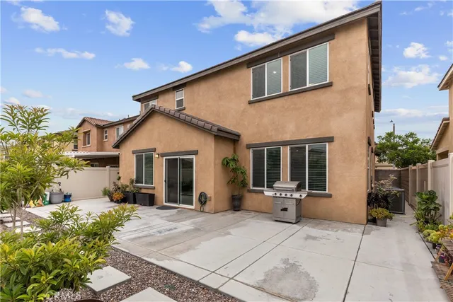a front view of house with yard and trees in the background