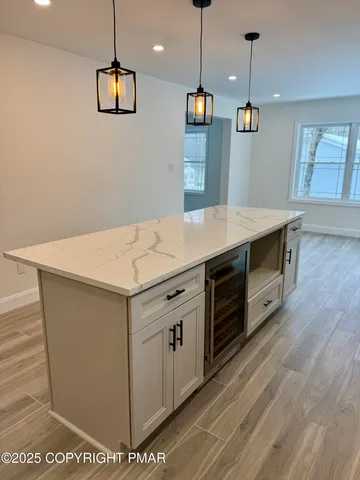 an empty room with wooden floor and window