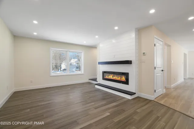 a kitchen with a stove a sink and a wooden floor