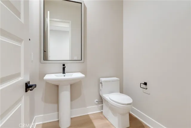 a white toilet sitting next to a white sink