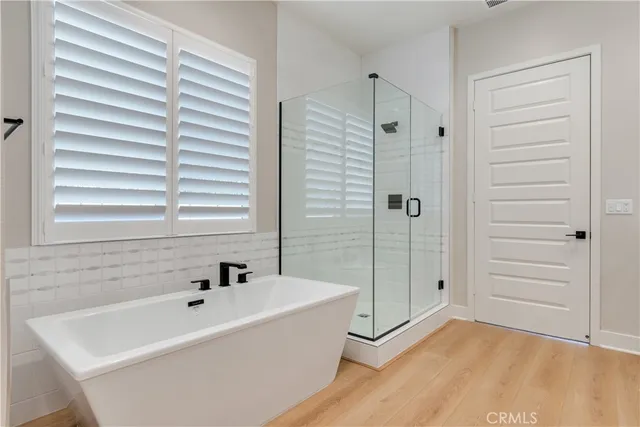 a bathroom with a shower sink and mirror