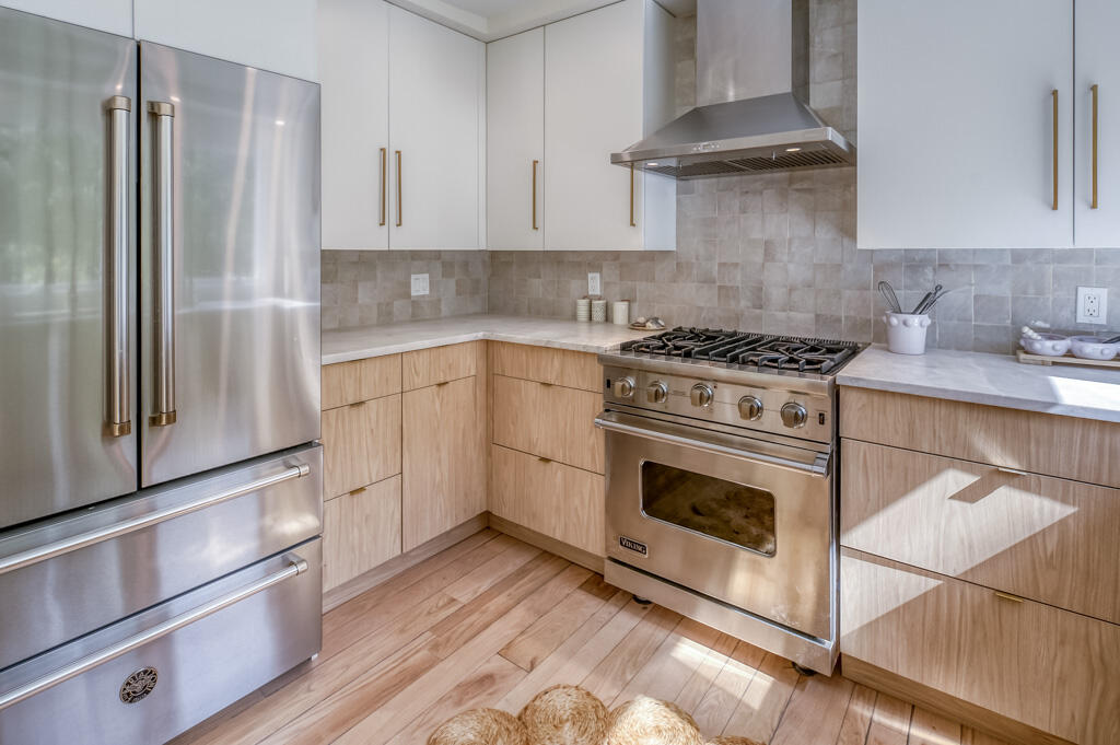 99 The Boulevard Edgartown, MA 02539 - Photo 12 of 35 a kitchen with granite countertop a stove top oven cabinets and stainless steel appliances