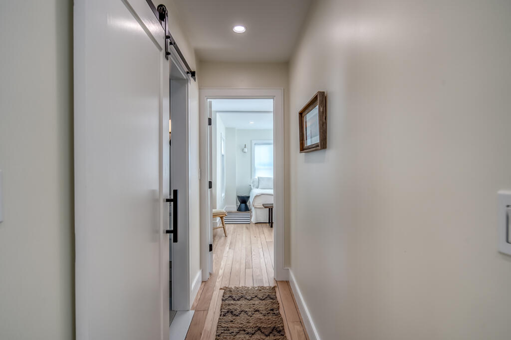 99 The Boulevard Edgartown, MA 02539 - Photo 13 of 35 a view of a hallway with wooden floor and bathroom