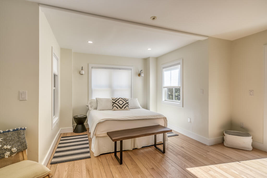99 The Boulevard Edgartown, MA 02539 - Photo 14 of 35 a bedroom with a bed and wooden floor