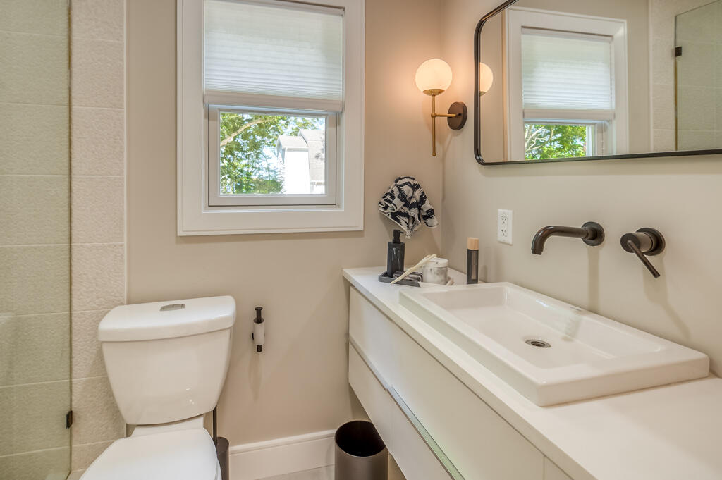 99 The Boulevard Edgartown, MA 02539 - Photo 16 of 35 a bathroom with a toilet sink and mirror