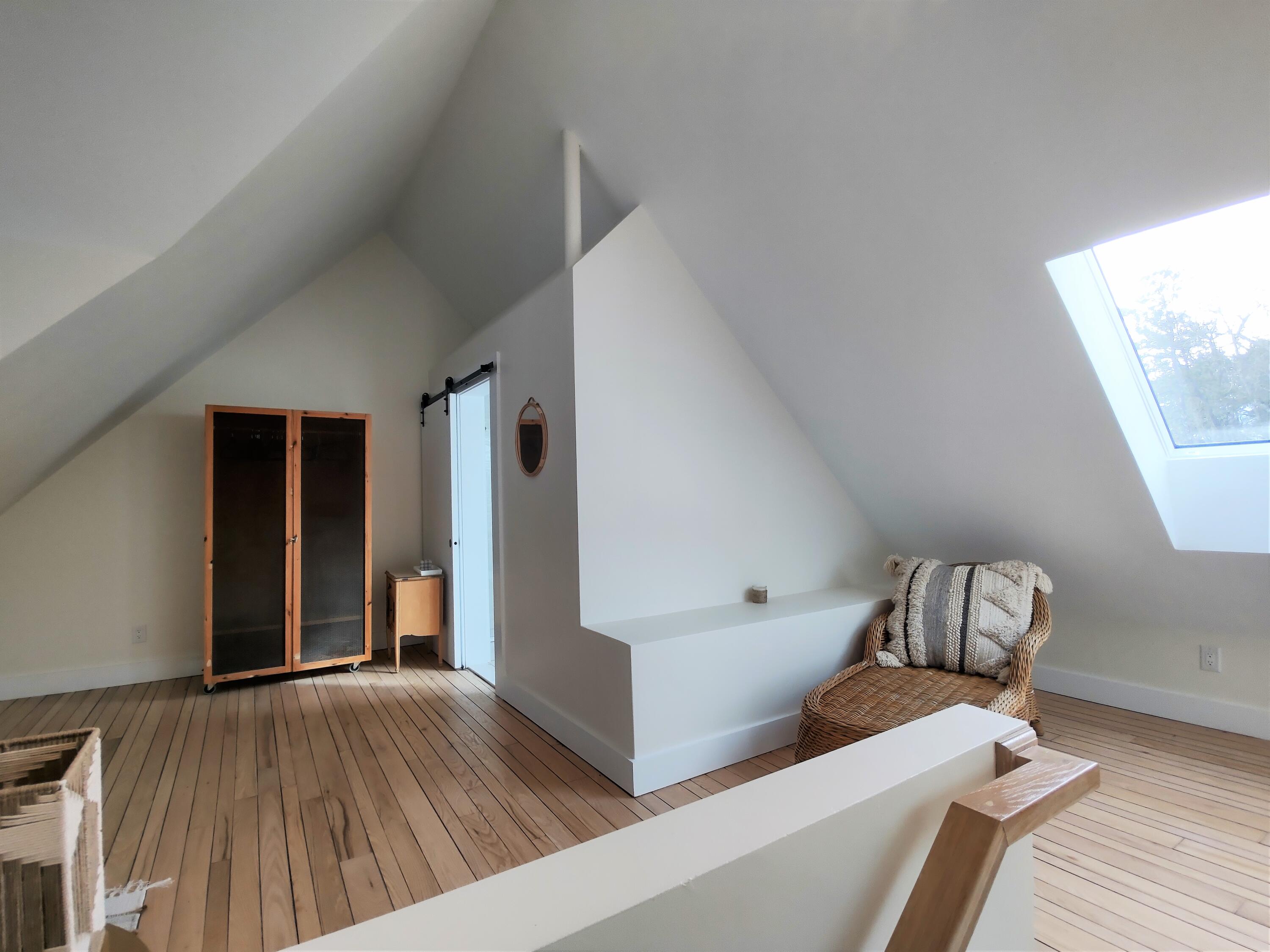 99 The Boulevard Edgartown, MA 02539 - Photo 27 of 35 a view of living room and bedroom with furniture and wooden floor